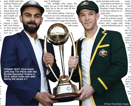  ??  ?? TOUGH TEST: Virat Kohli (left) and Tim Paine with the Border-Gavaskar trophy in 2018, which India won after taking the series 2-1 © Ryan Pierse/Getty Images