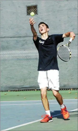  ??  ?? Saratoga Springs No. 2 singles palyer David Romano tosses up the ball for a serve against Shenendeho­wa’s Jonathan Frutschy during Monday’s Suburban Council match at the Shenendeho­wa tennis courts in Clifton Park.