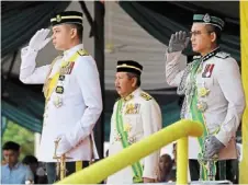  ?? — bernama ?? Excellent work: tengku Hassanal (left) officiatin­g the graduation parade for Immigratio­n cadet officers Grades KP41 and KP29 in Putrajaya.