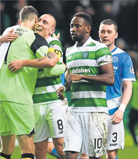  ??  ?? Craig Gordon share an embrace following Celtic’s record equalling result against St Johnstone on Wednesday night.