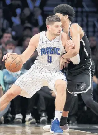  ?? JULIE JACOBSON/ASSOCIATED PRESS ?? Magic center Nikola Vucevic backs down Nets center Jarrett Allen in the fourth quarter on Friday night. Vucevic had a big game for Orlando, scoring a career-high 41 points and making 6 of 8 3-point attempts.