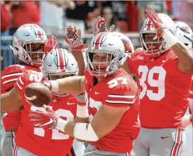  ?? DAVID JABLONSKI / STAFF ?? Ohio State defensive end Nick Bosa celebrates after recovering a fumble for a touchdown against Oregon State on Saturday in Columbus.