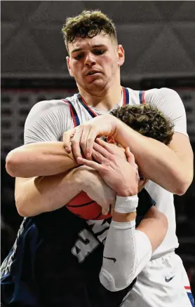  ?? Jessica Hill/Associated Press ?? UConn’s Donovan Clingan, top, and New Hampshire’s Jaxson Baker fight for a rebound on Nov. 27 in Storrs. Clingan returned to action on Wednesday after missing five games with a foot injury.