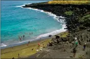 ?? ASSOCIATED PRESS ?? IN THIS 2014 FILE PHOTO, people sunbathe at Papakolea green sand beach near Ocean View, Hawaii. Online auction and sales company eBay has removed multiple listings of sand said to be taken from Hawaii beaches.