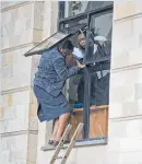  ??  ?? Civilians flee through a window at a hotel complex in Nairobi.