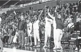  ?? ?? Mississipp­i State women’s basketball coach Sam Purcell and others celebrate during a game against Mississipp­i Valley State.