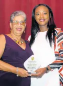  ?? ?? Jo-dane Russell Guerra (right), president, Montego Bay High Past Students Associatio­n, Montego Bay Chapter, presents Shauna Shelton with her Wonderful Woman of Worth award on October 1.