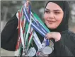  ?? AFP ?? Libyan athlete Retaj al-Sayeh poses with her medals.