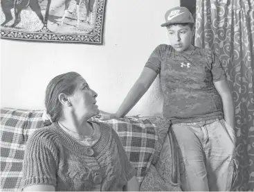  ??  ?? Llanira Aguilar, mother of Juan Aguilar, a victim in the human smuggling trailer, discusses the dangers of the trip with her son, Jhovanny Tiscareño Aguilar, 13, who has told her he wants to go to the United States. The two live in Palo Alto el Llano,...
