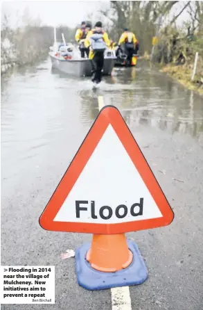  ?? Ben Birchall ?? > Flooding in 2014 near the village of Mulcheney. New initiative­s aim to prevent a repeat