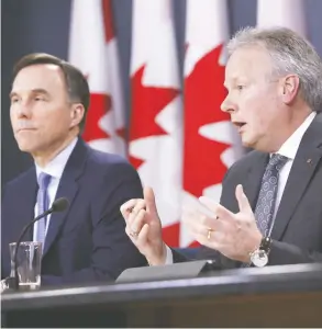  ?? DAVID KAWAI / BLOOMBERG ?? Stephen Poloz, governor of the Bank of Canada, right, speaks while Bill Morneau, Canada’s minister of finance, listens during a news conference in Ottawa on Friday.