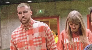  ?? CHARLIE RIEDEL/AP ?? Chiefs tight end Travis Kelce and singer Taylor Swift leave Arrowhead Stadium after a win against the Chargers in Kansas City on Oct. 22.