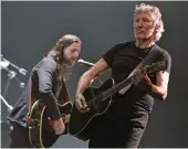  ?? — AP ?? Former member of Pink Floyd, British singer and songwriter Roger Waters ( right) performs in Zurich, Switzerlan­d, on Monday.