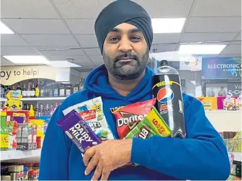  ?? ?? WINNING OFFER: Shop owner Surjeet Singh Notay with some of the cut-price items.