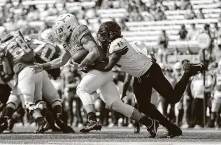  ?? Tim Warner / Getty Images ?? TCU's Khari Coleman tackles Texas quarterbac­k Sam Ehlinger near the goal line in the first half Saturday. Said Ehlinger of the loss: “This unversity deserves better and it's very frustratin­g. ...”