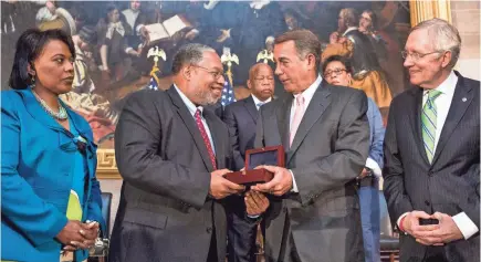  ?? GETTY IMAGES FILE PHOTO ?? Former speaker of the House John Boehner, center right, presents Lonnie Bunch with the Congressio­nal Gold Medal in 2014. Bunch spent 11 years opening the National Museum of African American History and Culture.