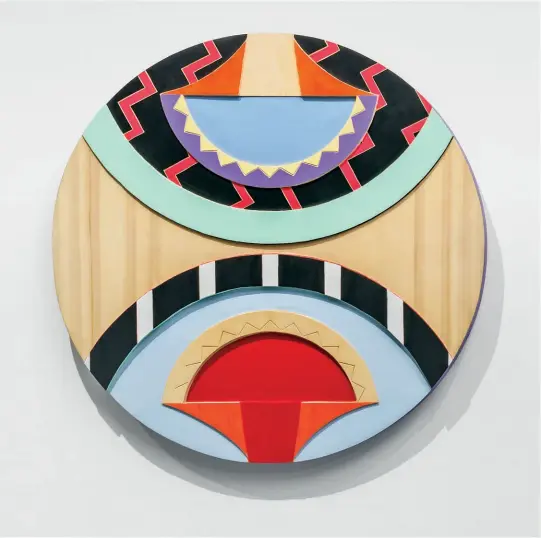  ??  ?? Jordan Bennett DoubleWalq­u’n 2016 Acrylic paint on carved yellow cedar 71.1 cm (diam.) All Photos Ernest Mayer
Opposite Installati­on of Boarder X at the Winnipeg Art Gallery, 2017