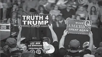  ?? NEW YORK
-AP ?? Signs referring to the QAnon conspiracy theory with a Q have appeared at rallies for President Trump.