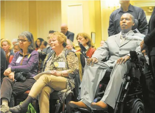  ?? STAFF FILE ?? O. J. Brigance, a former Ravens football player who has the neurodegen­erative disease ALS, waits to testify against a bill to legalize physician-assisted death last year. Seated next to him is a supporter of the bill, Catherine Weber, with Maryland Action Team for Compassion & Choices. New versions of the bill are again before the legislatur­e.