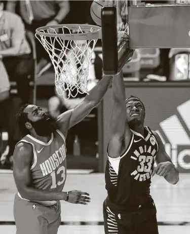  ?? Kim Klement / Getty Images ?? The Pacers’ Myles Turber slips inside James Harden during the third quarter of Indiana’s victory Wednesday. Turner, a former University of Texas player, had 18 points and 12 rebounds.