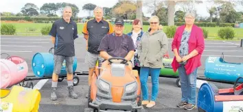  ??  ?? Volunteer Bill Schrader at the wheel with Karl Newport (South Taranaki Panel and Paint) John Burling (Carac Group), Wendy Foreman (Neighbourh­ood Support), Tanya Grant (First Call Maintenanc­e), and Carol Curtis Neighbourh­ood Support).