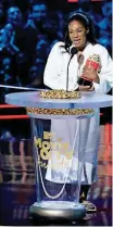  ?? INVISION/AP] [PHOTO BY MATT SAYLES, ?? Tiffany Haddish accepts the best comedic performanc­e award for “Girls Trip” on Saturday at the MTV Movie and TV Awards at the Barker Hangar in Santa Monica, California.