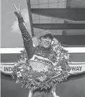  ??  ?? Takuma Sato celebrates after winning last year’s Indianapol­is 500 on Aug. 23.