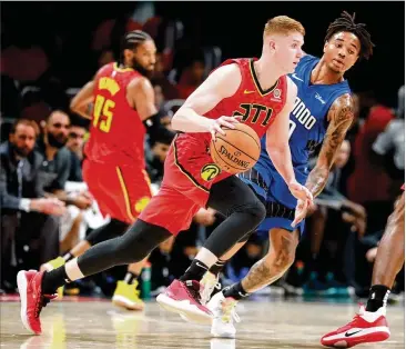  ?? CURTIS COMPTON / CCOMPTON@AJC.COM ?? Kevin Huerter drives against the Magic in an Oct. 26 game in Atlanta. Huerter was injured Nov. 12 and missed 11 games but returned to action Wednesday night as the Hawks faced the Nets.