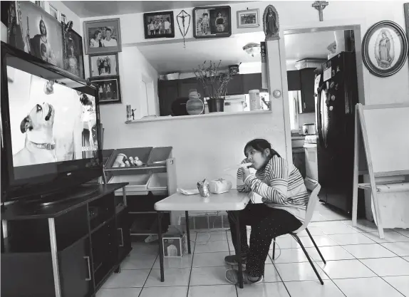  ??  ?? Annabel Rodriguez-santos, 8, does a nebulizer breathing treatment for her asthma. In the north Denver neighborho­od known as Elyria-swansea, where Annabel and her family live, the asthma rate jumped 41 percent since 2006-2010 to 1,113.12 per 100,000 people in the 2013-2017 span.