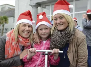  ??  ?? Adrienne Harrington and Sandra O Dell with Keelan Donnelly. Below, some of the runners at the santa run.