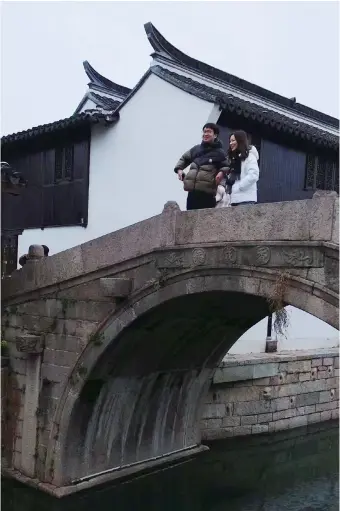  ?? ?? A couple of lovers stand on a stone bridge first built in the 14th century and revamped in the 18th century. — All photos by Wang Yong