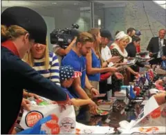  ?? DONNA ROVINS - DIGITAL FIRST MEDIA FILE PHOTO ?? Volunteers from the hospitalit­y industryin and around King of Prussia stuff welcome bags in July to be presented to Democratic Convention delegates when they checked into their hotels.