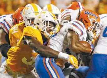  ?? STAFF PHOTO BY C.B. SCHMELTER ?? Tennessee’s Daniel Bituli wraps up Florida running back Jordan Scarlett during last season’s game at Neyland Stadium. The senior is returning to a linebackin­g unit that should have more depth this season.