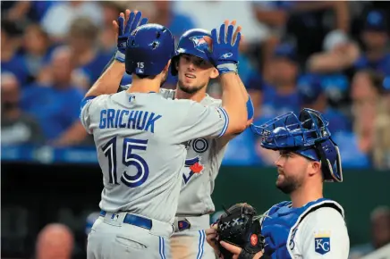  ?? AP PHOTO ?? Toronto Blue Jays right fielder Randal Grichuk (15) celebrates his two-run home run with teammate Cavan Biggio, back, during the sixth inning of a game at Kauffman Stadium in Kansas City, Mo., on Monday.