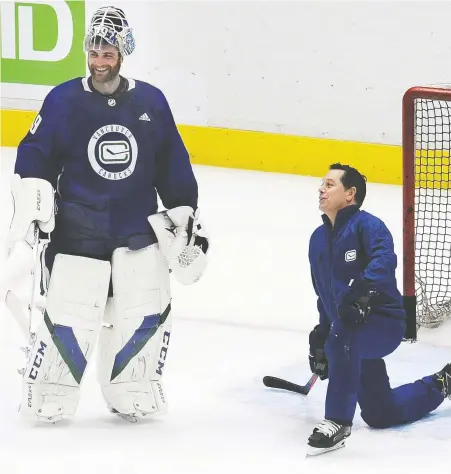  ?? NICK PROCAYLO ?? Canucks goalie Braden Holtby has been discussing his game and the art of netminding with goaltendin­g coach Ian Clark for the past month. The two were on the ice putting words into practice at Vancouver's first on-ice training camp session at Rogers Arena on Monday.