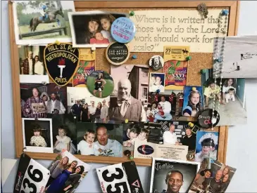  ?? RODNEY HO / RHO@AJC.COM ?? Mike Pniewski has a bulletin board in his basement office with mementos and family photos from years past.