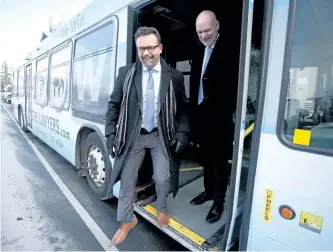  ?? JASON BAIN/PETERBOROU­GH EXAMINER ?? City transporta­tion chairman Don Vassiliadi­s and Wolfe Injury Lawyers president Bill Wolfe check out a city bus in front of City Hall as free public transit on New Year's Eve was announced on Dec. 7. Bus rides will be free on New Year's Eve, but...