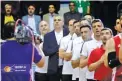  ??  ?? iribf.ir Head coach of Iran’s national basketball team Mehran Shahintab (seen in black suit) stands respectful­ly during Iran’s national anthem before his side’s match against Australia at Azadi Hall in the Iranian capital of Tehran on February 24, 2019.