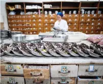  ?? AFP ?? A woman mixing medicine in the pharmacy of the Yueyang Hospital, part of the Shanghai University of Traditiona­l Chinese Medicine, in Shanghai. —