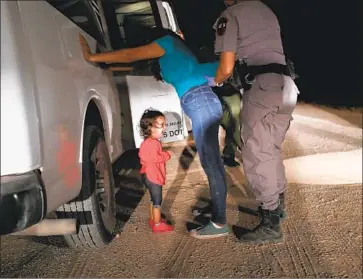  ?? John Moore Getty Images ?? A HONDURAN asylum seeker cries as her mother is searched near the U.S.-Mexico border on June 12, 2018, in McAllen, Texas. The asylum seekers were detained and sent to a processing center for possible separation.