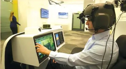  ??  ?? A MAN demonstrat­es Elbit System’s advanced helmet mounted system, at its offices in Haifa earlier this year.