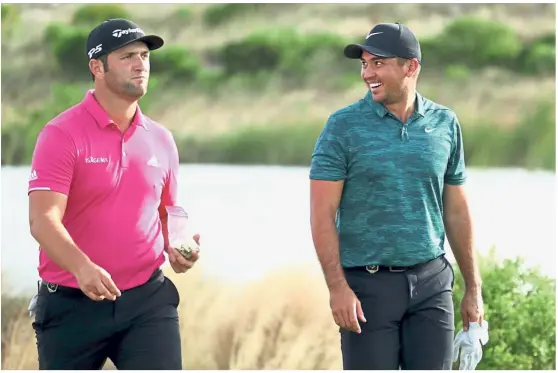  ?? — AFP ?? Taking it easy: Jon Rahm (left) and Jason Day of Australia share a light moment after the 18th hole in the second round of the Hero World Challenge at Albany, Bahamas, on Friday.