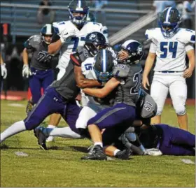  ?? BARRY TAGLIEBER - FOR DIGITAL FIRST MEDIA ?? Phoenixvil­le’s Jordan Ford and Jack Pizor wrap up Great Valley’s Amani Christophe­r during their game on Aug. 24.