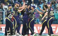  ?? PTI ?? Kolkata Knight Riders’ players celebrate after the dismissal of Rajasthan Royals batsman Sanju Samson.