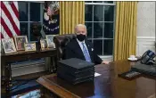  ?? EVAN VUCCI — THE ASSOCIATED PRESS ?? President Joe Biden signs a series of executive orders in the Oval Office of the White House,
Jan. 20, in Washington.