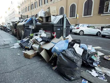  ?? (foto Panegrossi/ LaPresse) ?? ProtestaA sinistra la manifestaz­ione dei lavoratori dell’Ama ieri mattina a piazza Santi Apostoli e, qui accanto, una catasta di rifiuti in via Sicilia, tra via Veneto e piazza Fiume