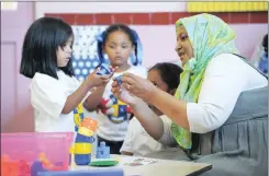  ?? Picture: HENK KRUGER ?? EASY PEASY: Nuhaa Isaacs is taught some building skills during her first day at school at Schotsche Kloof Primary school in Bo-Kaap.