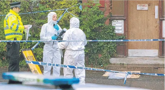  ??  ?? Police and forensics officers at the flats in Dundonald Court, Arklay Street, where a man was found dead on Sunday evening.