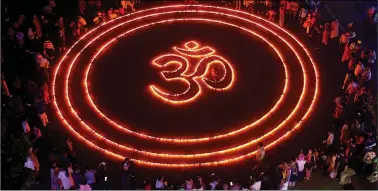  ?? REUTERS ?? People light lamps as they make a formation of “Om” on the eve of Diwali in Chandigarh on Saturday.