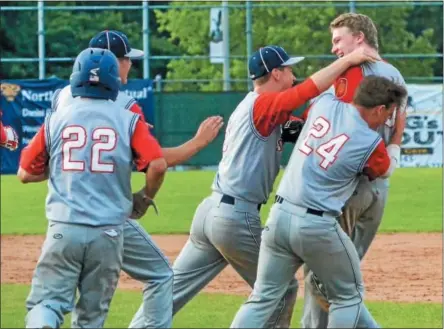  ?? KYLE MENNIG — ONEIDA DAILY DISPATCH ?? Sherrill Post’s Davey Moffett is mobbed by his teammates after his game-winning hit against Binghamton Post during their American Legion Baseball State Championsh­ip tournament game in Utica on Tuesday.